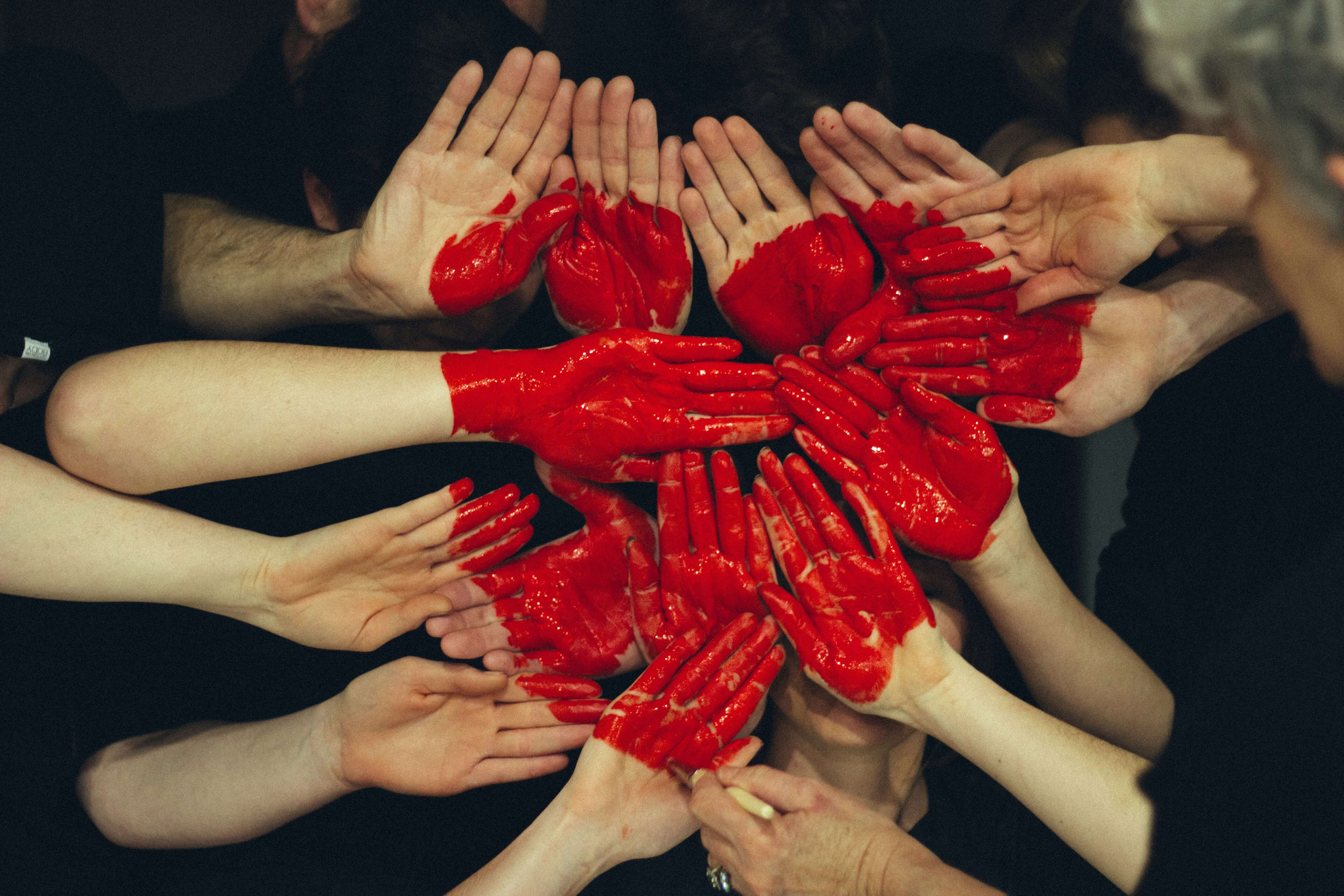 Hands painted to look like a heart.